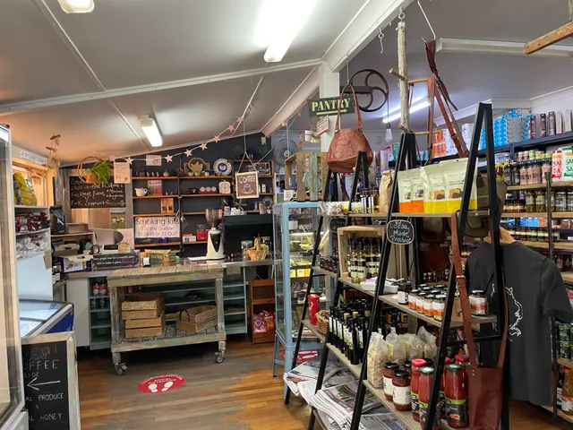 Shelves of sauces and preserves under the pantry sign.